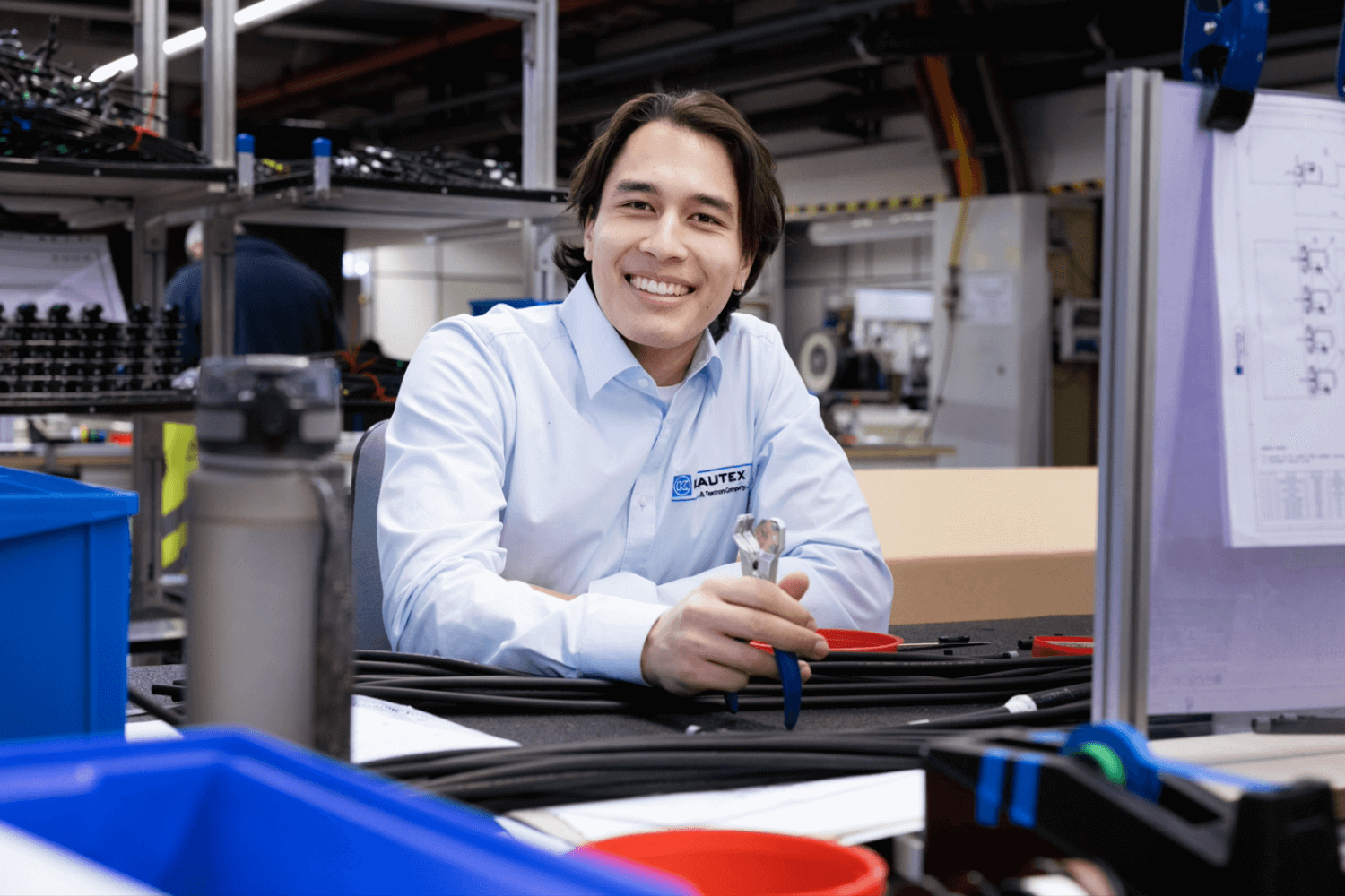 Man sitting in front of a computer holding a wrench